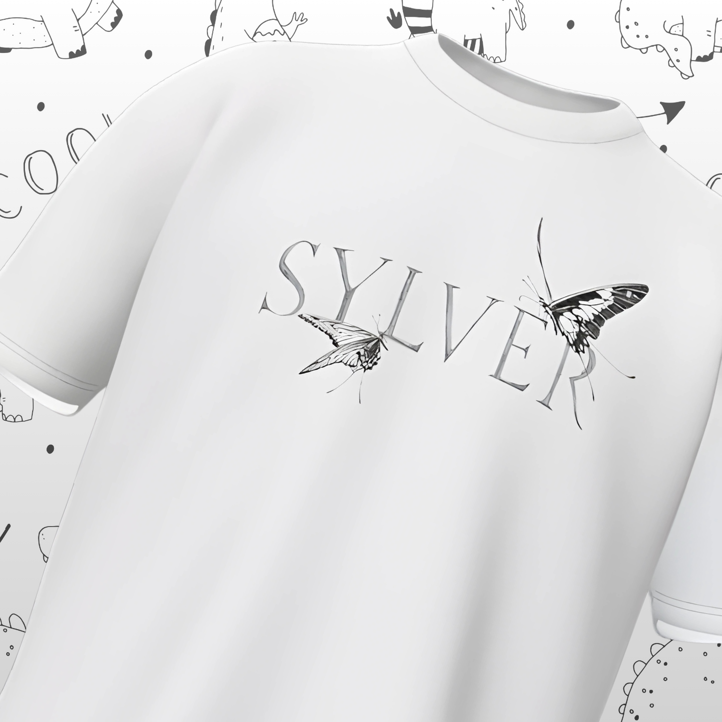 White t-shirt with 'SYLVER' and butterfly design on a light gray background with small illustrations.