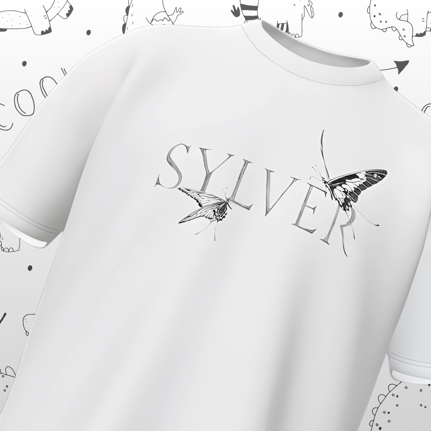 White t-shirt with 'SYLVER' and butterfly design on a light gray background with small illustrations.